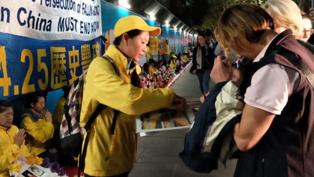 During a peaceful protest in Australia, Angel tells passers-by about the persecution of Falun Gong in China.